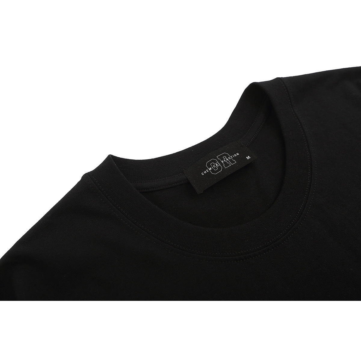 Close-up of a black T-shirt's ribbed crew neckline and inner label.