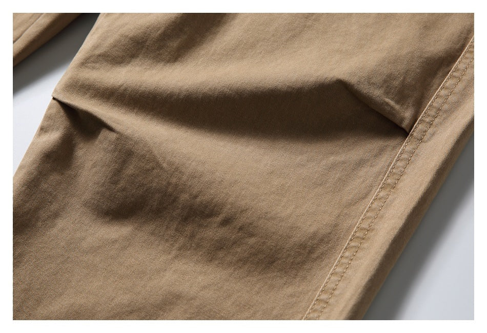 Close-up of tan fabric and a double-stitched side seam on the bottoms.