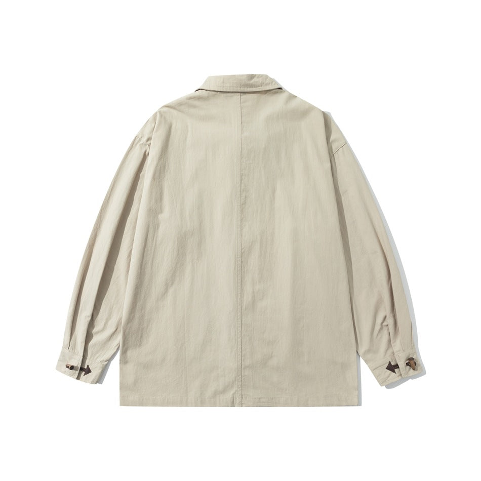 Back view of a light beige long-sleeved collared jacket with a center seam and toggle details at the cuffs.