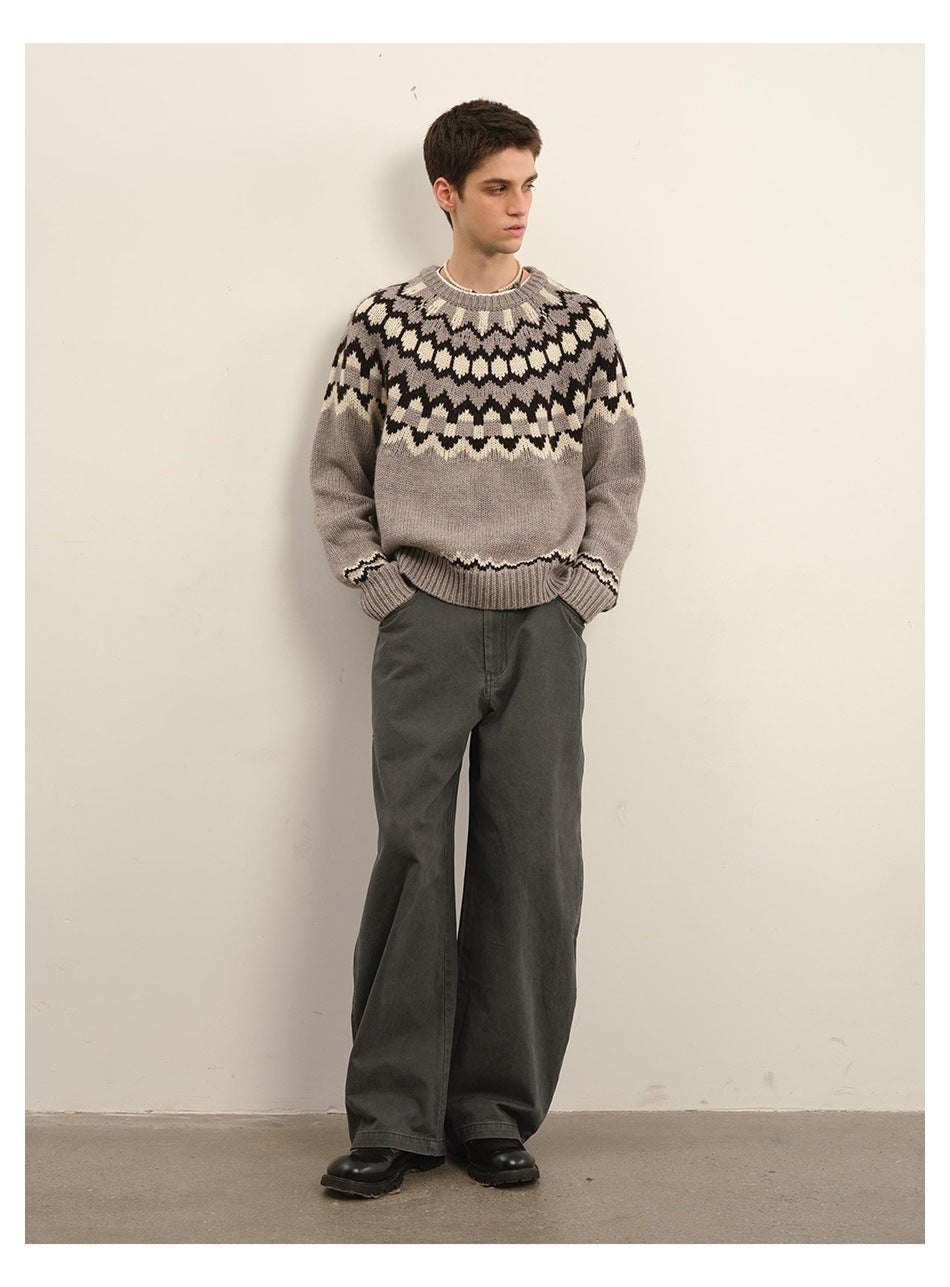 Model wearing gray patterned knit sweater with wide-leg dark gray pants and black boots, full-length front view