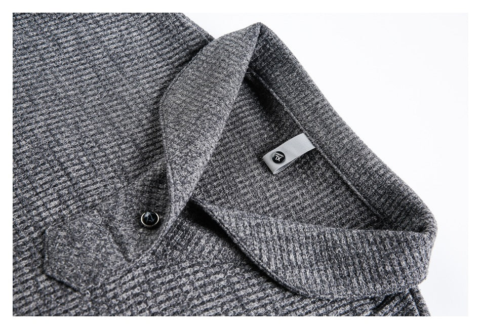Close-up of a charcoal gray textured knit collar, button, and inner label marked XL.