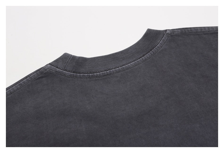 Close-up of the charcoal T-shirt's back neckline and shoulder seams.