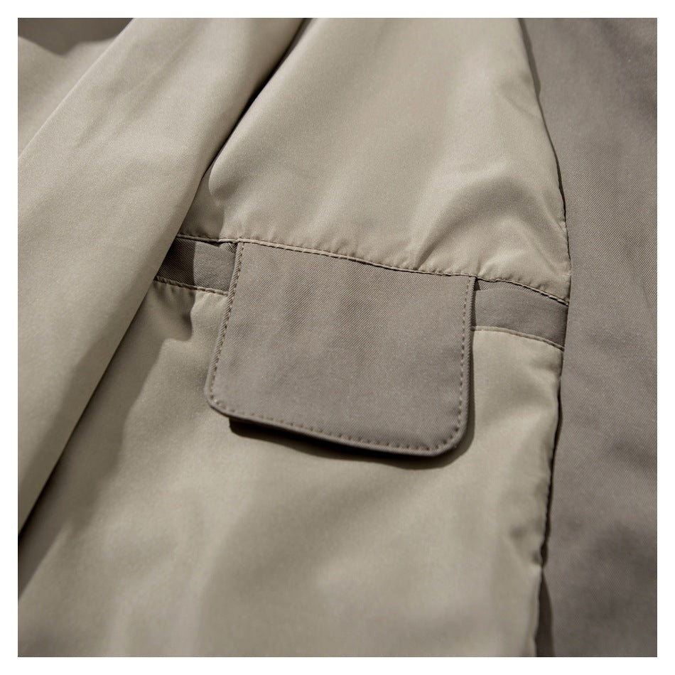 Close-up of a taupe garment's interior pocket and lining.