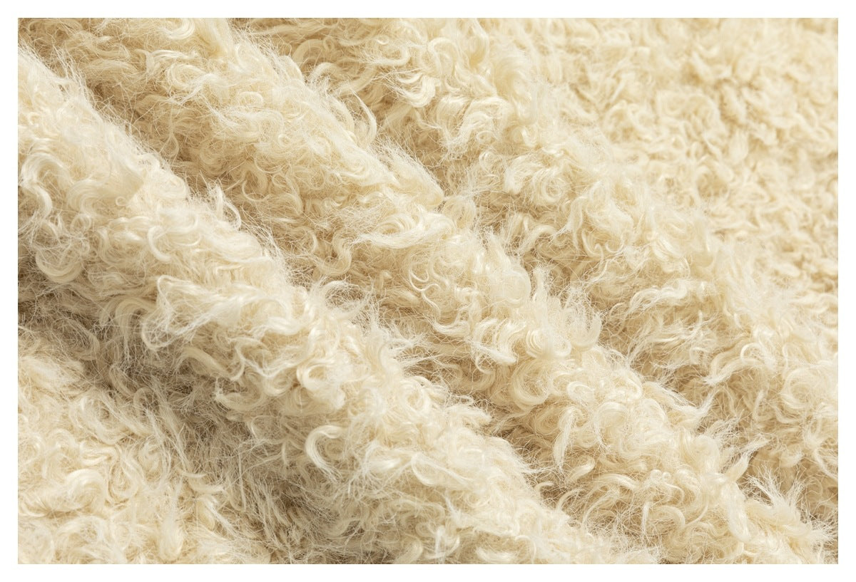 Extreme close-up of dense cream curly-pile garment texture.