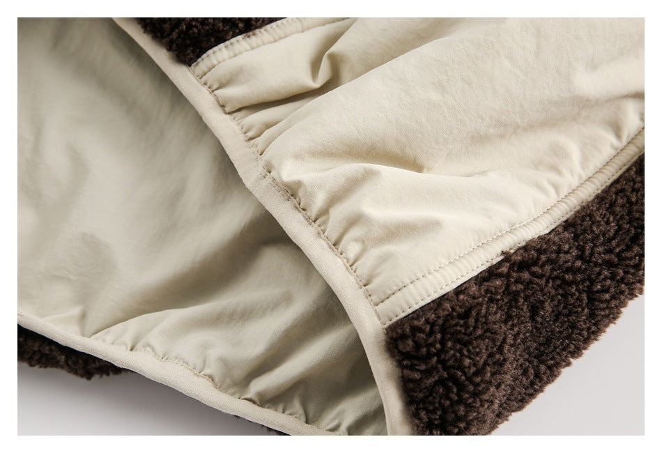 Close-up of the cream lining and stitched panel inside a dark brown fleece garment.