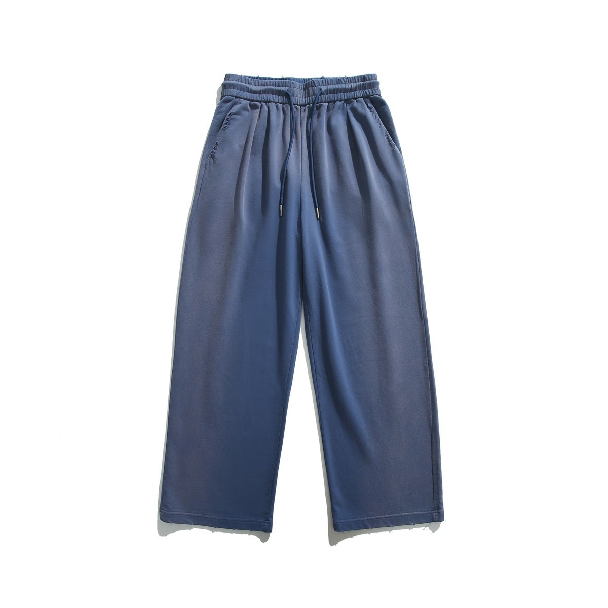 Washed blue wide-leg sweatpants flat lay with elastic waist, navy drawstring, side pockets and frayed hem