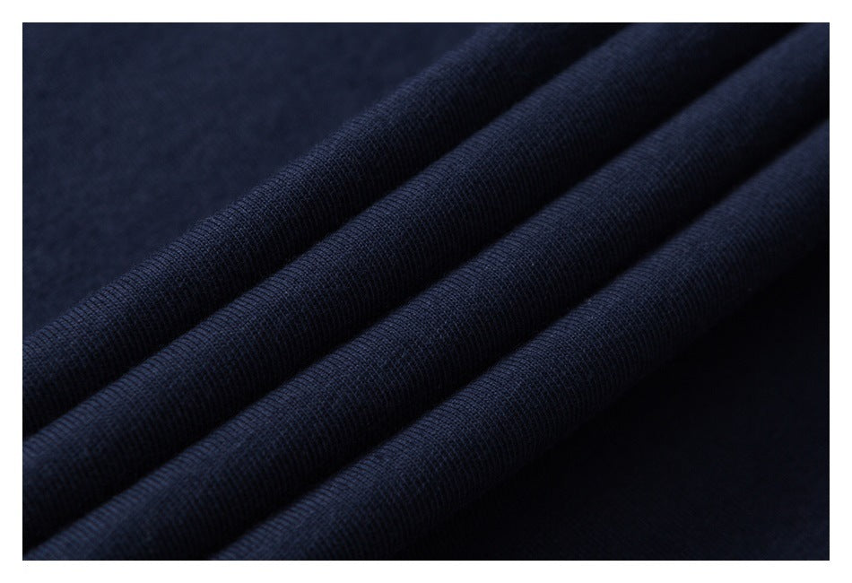 Close-up of dark navy fabric arranged in soft folds, showing its surface texture.