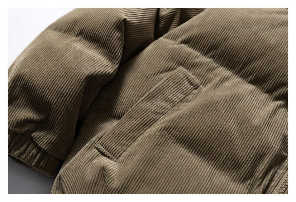 Close-up of a front pocket and sleeve on the olive-brown ribbed jacket.