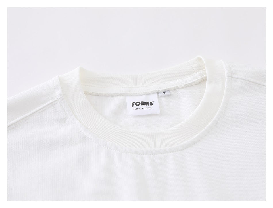 Close-up of the white shirt's ribbed crew neckline and sewn-in neck labels.