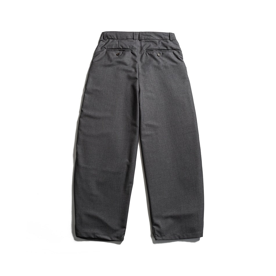 Back view of charcoal gray trousers with belt loops and two buttoned welt pockets.