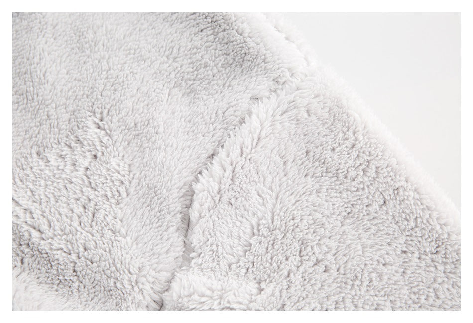 Close-up of the pale gray plush garment's collar and fuzzy fabric texture.