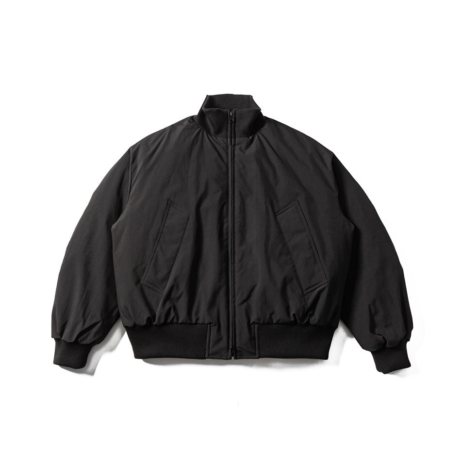 Black bomber-style puffer jacket flat lay, front view, with ribbed stand collar, zipper, slanted pockets and ribbed hem