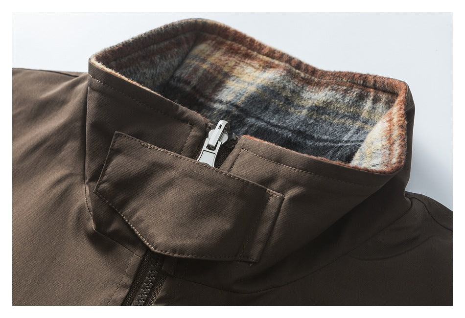 Close-up of the jacket's high collar, showing plaid lining, zipper, and a snap-fastening storm flap.