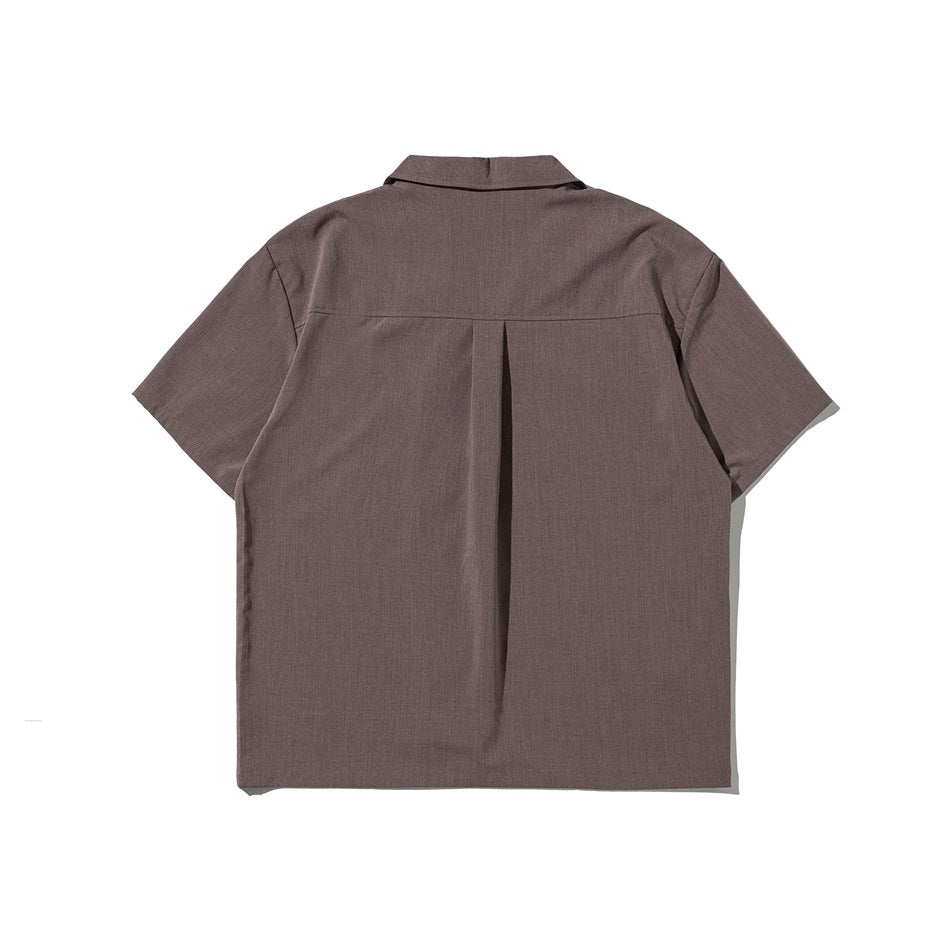 Back view of a brown short-sleeve shirt with a notched collar and center box pleat.