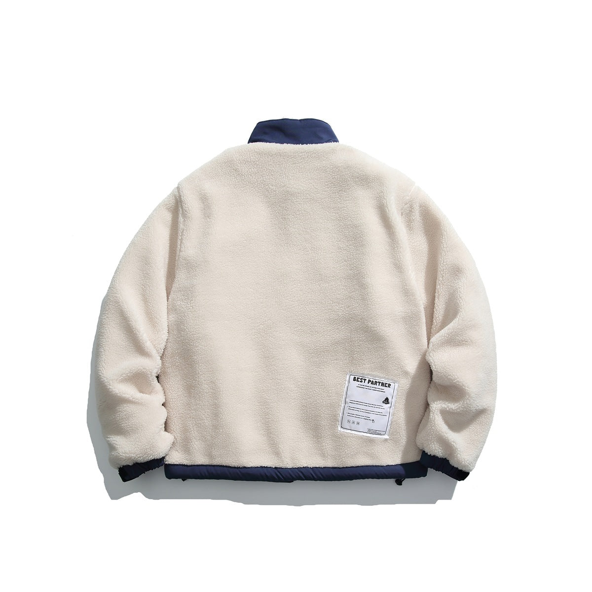 Back view of an ivory fleece jacket with a navy collar, cuffs, and hem, plus an attached lower-back label.