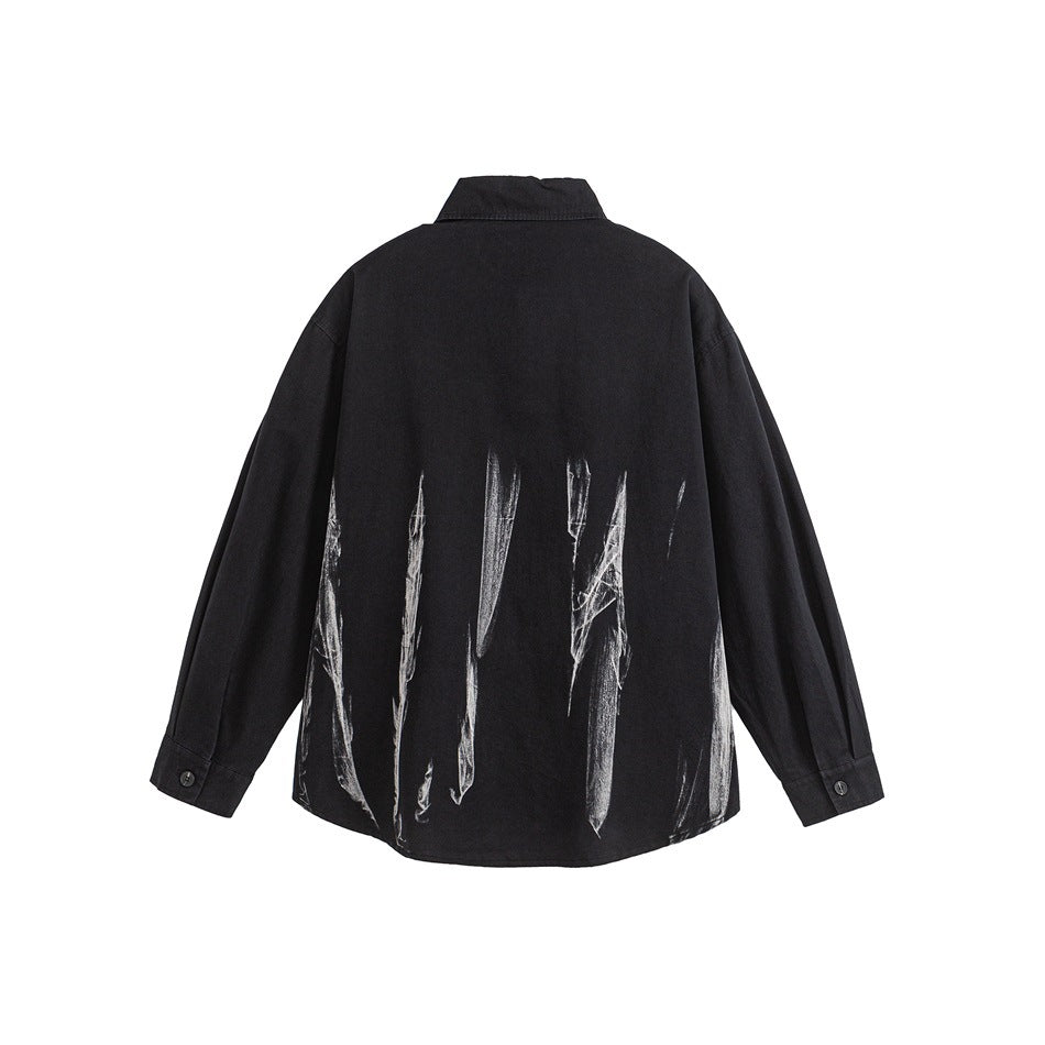 Back view of a black long-sleeve button-up shirt with white brushstroke graphics across the lower back.