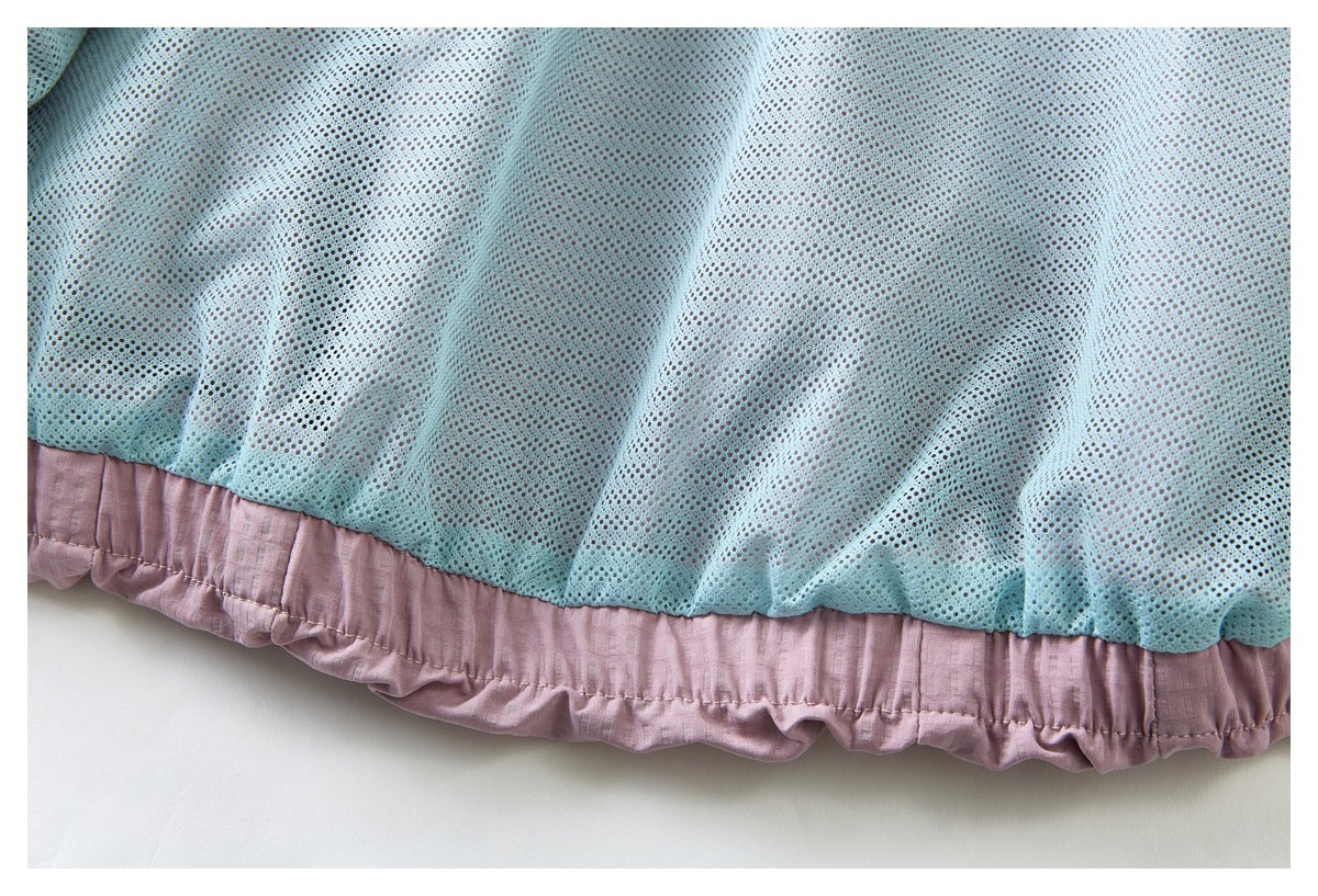 Close-up of pale blue mesh lining above the gathered dusty pink hem.