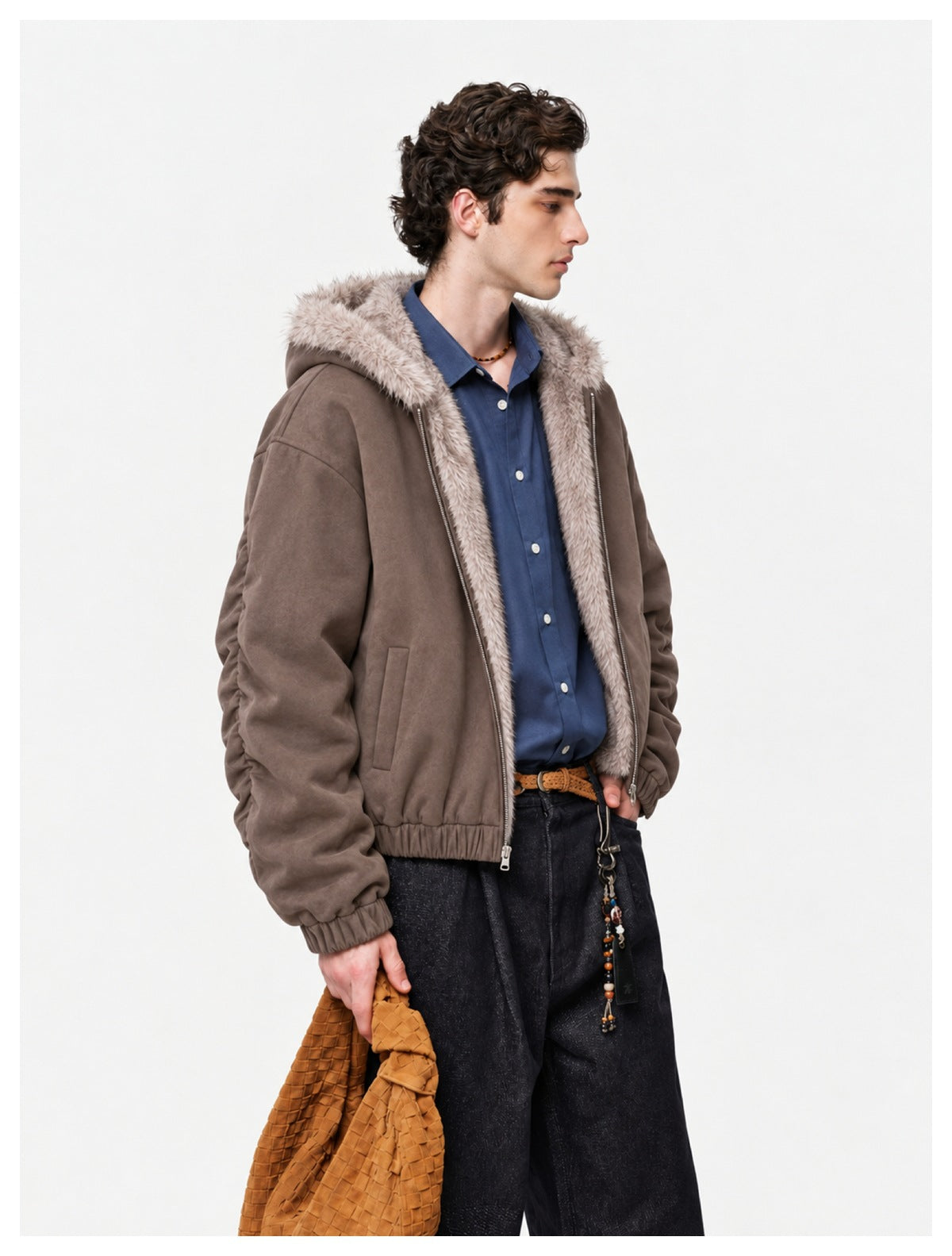 Man wearing a taupe zip-front jacket with a light fur-trimmed hood and gathered cuffs.