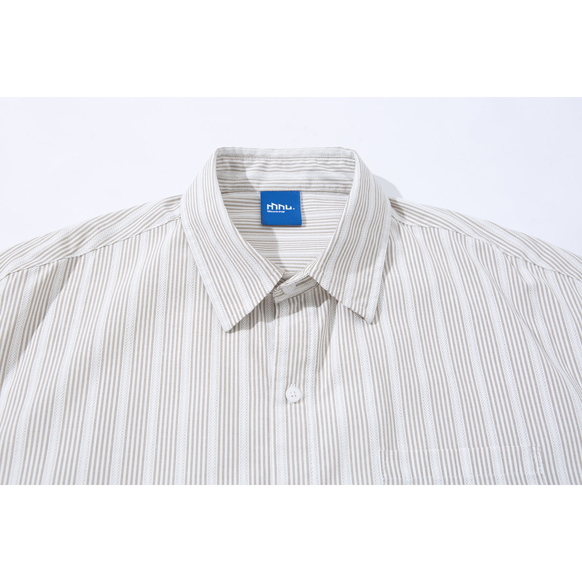 Close-up of a beige-and-white striped short-sleeve shirt showing its collar, button placket and chest pocket.