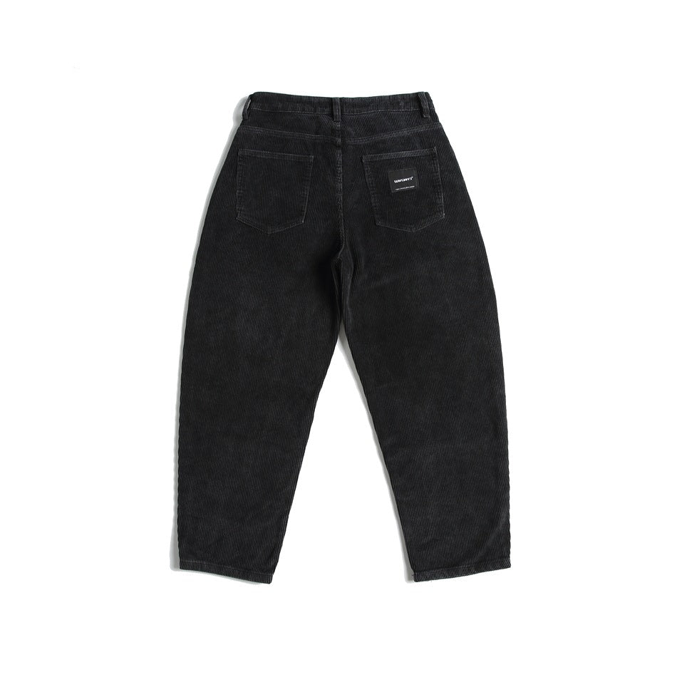 Back view of black ribbed trousers with two rear patch pockets and a small sewn label.