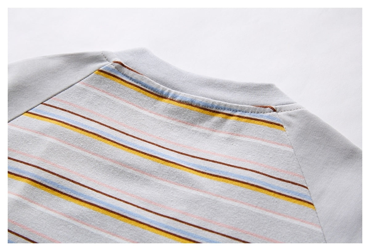 Close-up of a striped shirt neckline and upper back with solid gray raglan sleeves.