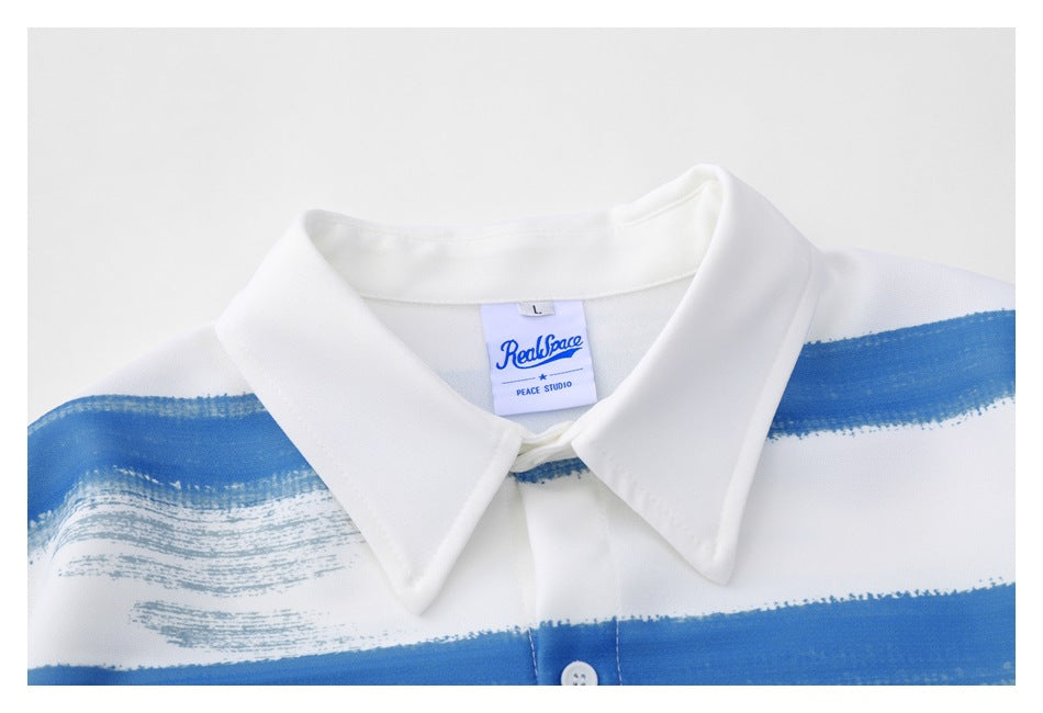 Close-up of a white shirt collar with a blue brushstroke stripe and a visible sewn-in label.