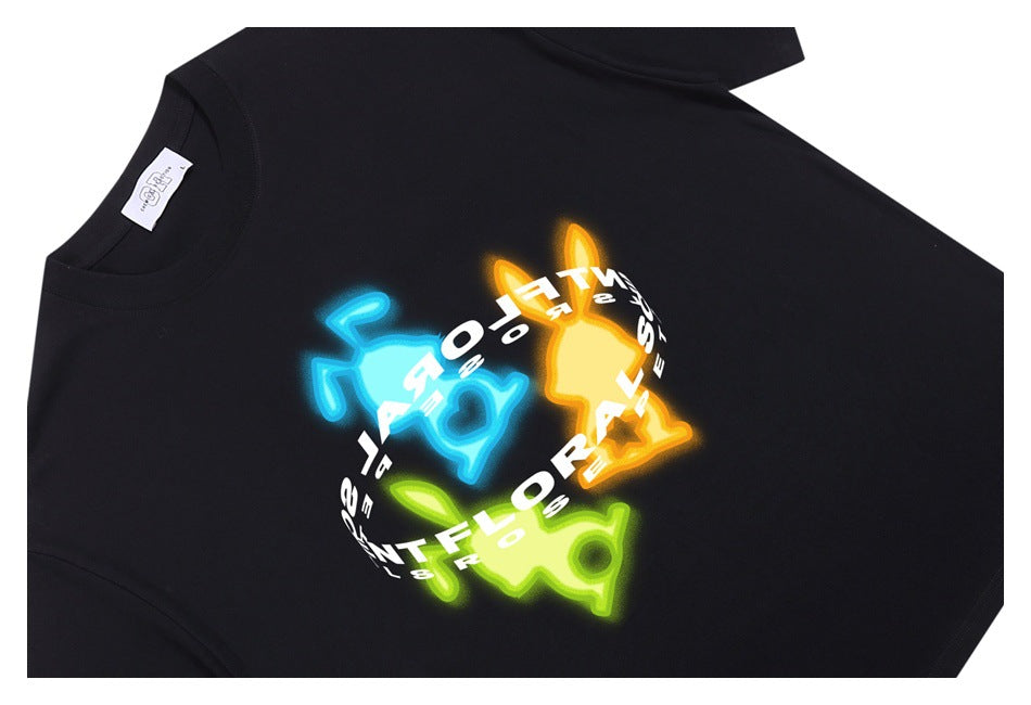 Black T-shirt laid flat with a colorful neon-style graphic and curved white lettering across the front.