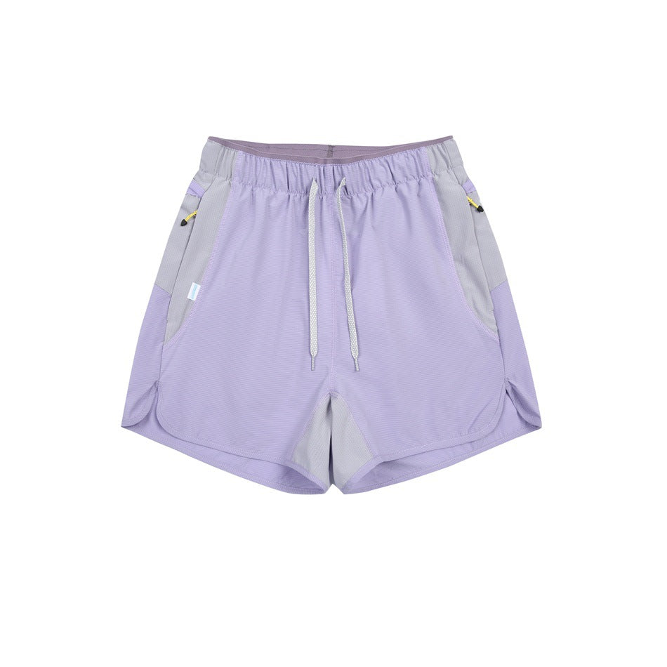 Light purple drawstring shorts with gray side panels, flat lay front view