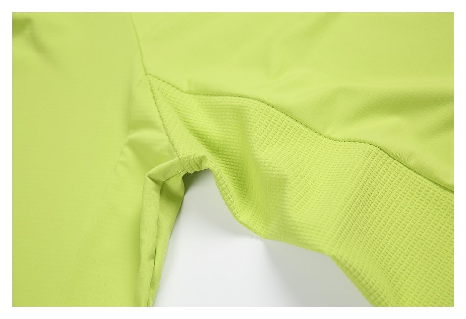 Close-up of a lime-green garment with a textured inset panel and visible seam.