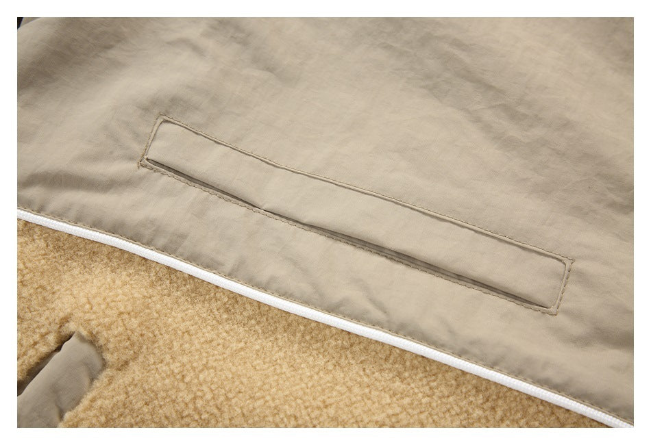 Close-up of a beige garment interior with a long stitched rectangular flap above white piping and tan fleece.