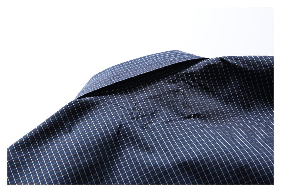 Close-up of the navy check shirt collar and upper back stitching.