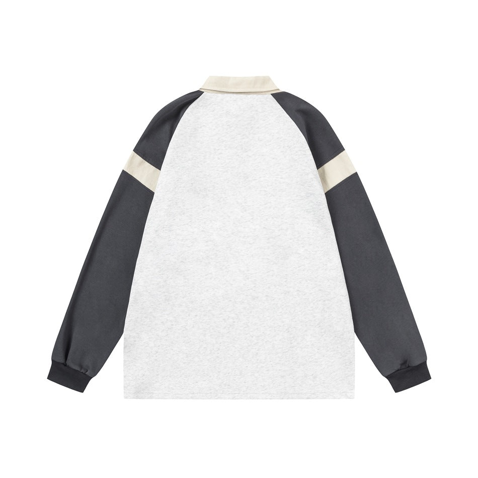 Back view of a long-sleeved top with a light gray marl body, charcoal sleeves, and cream sleeve bands.