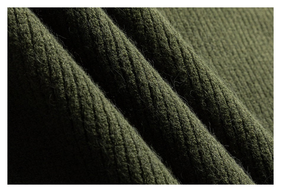 Macro view of the textured olive green knit fabric.