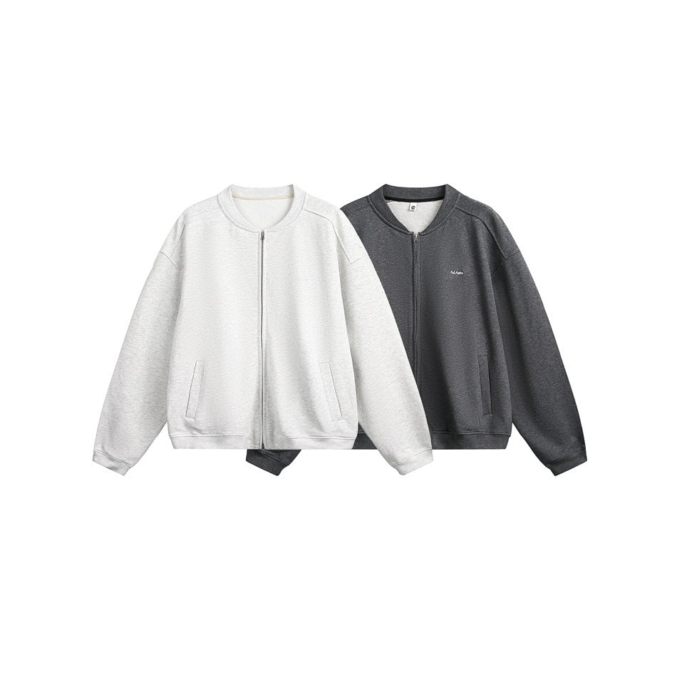 Two zip-front sweatshirts shown flat: one light gray and one dark charcoal, both with ribbed cuffs and pockets.