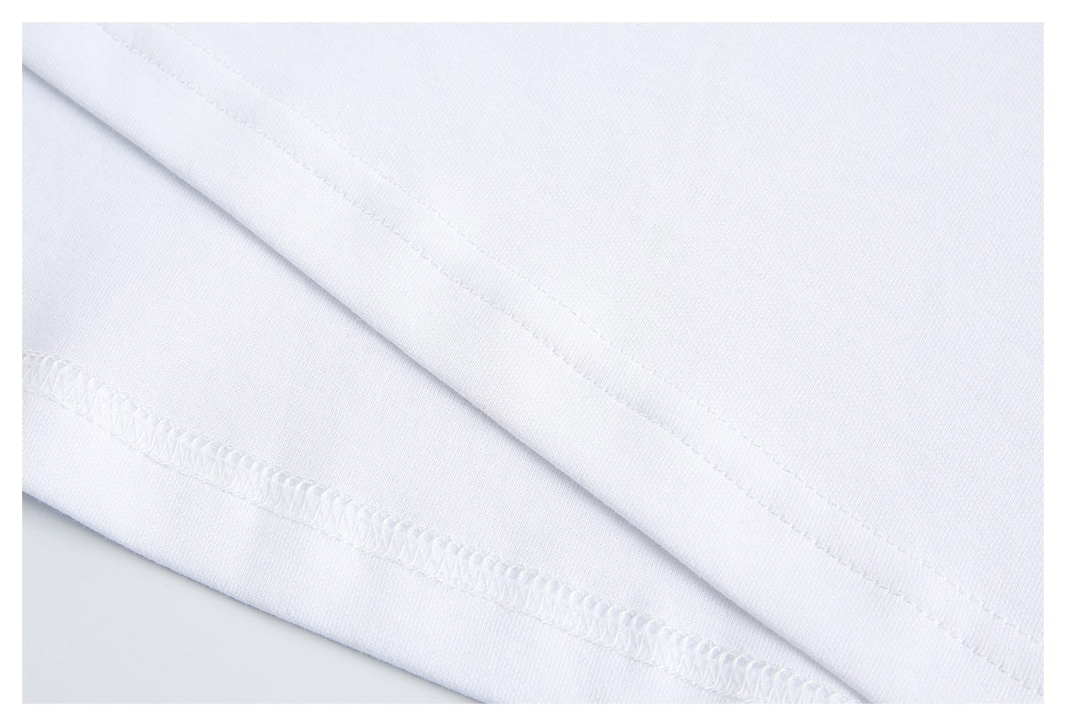 Close-up of a white garment's folded hem and overlock stitching.