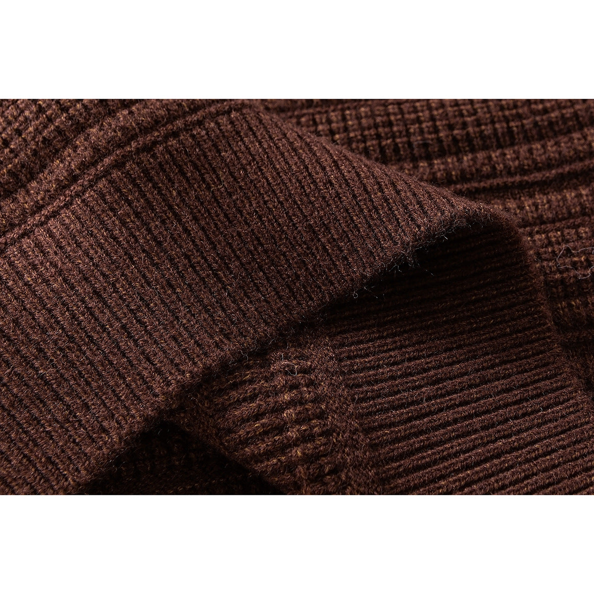 Close-up of dark brown ribbed knit fabric with a folded edge.