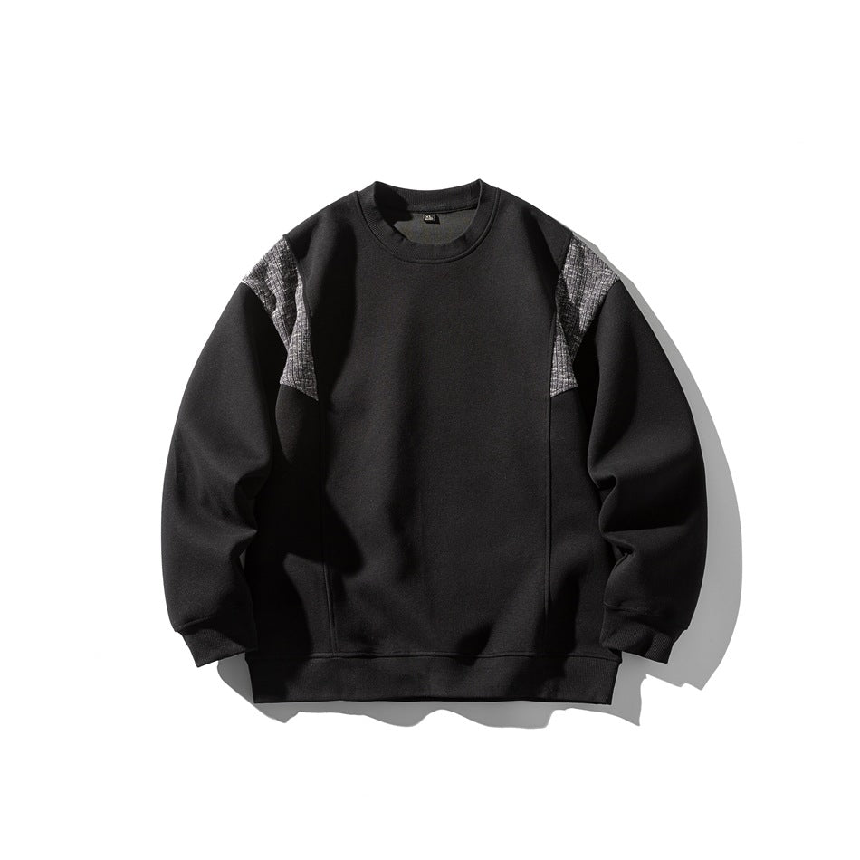 Black crew-neck sweatshirt flat lay with textured gray shoulder panels and ribbed cuffs and hem