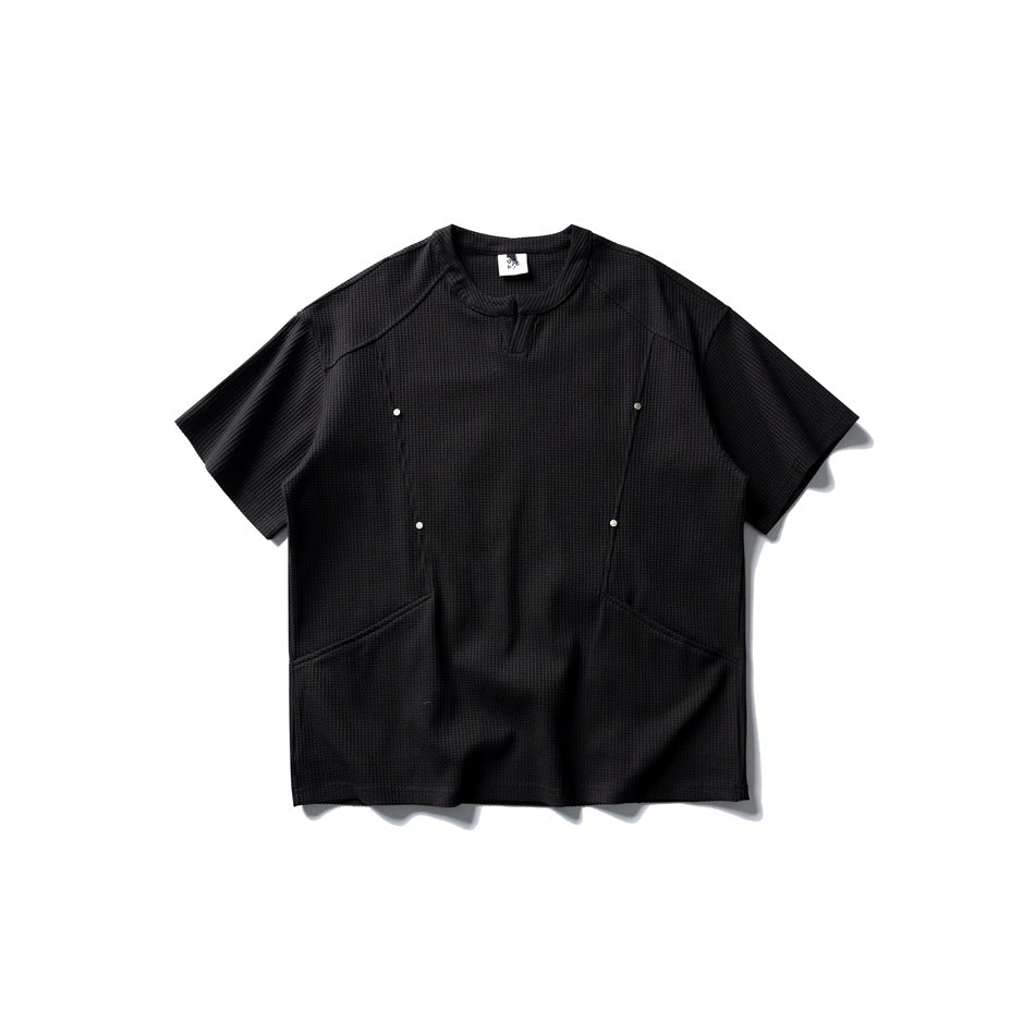 Black waffle-textured short-sleeve T-shirt, flat lay, with metal studs, seam details and curved lower front seams
