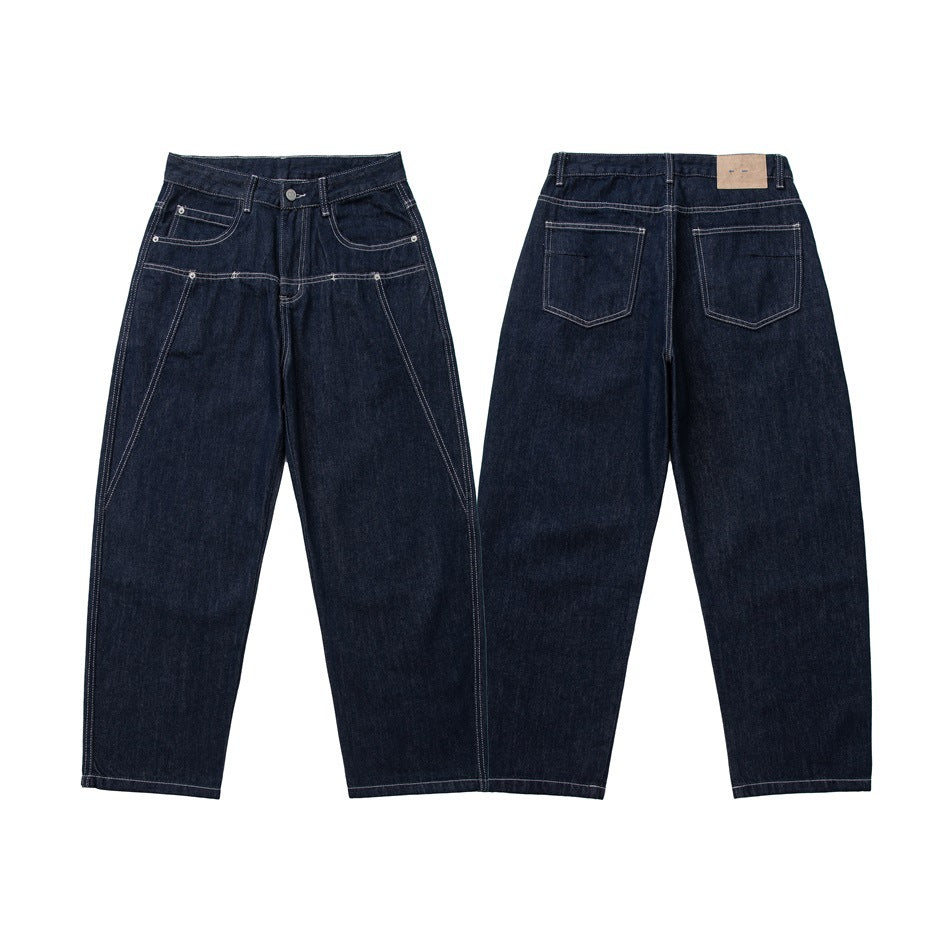 Front and back views of dark indigo jeans laid flat, with contrast stitching, multiple pockets and straight legs.
