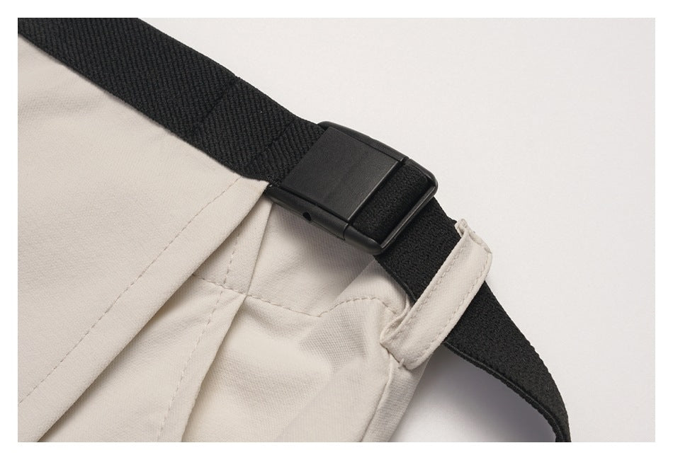 Close-up of the black strap buckle and beige fabric loop on the wrap skirt.