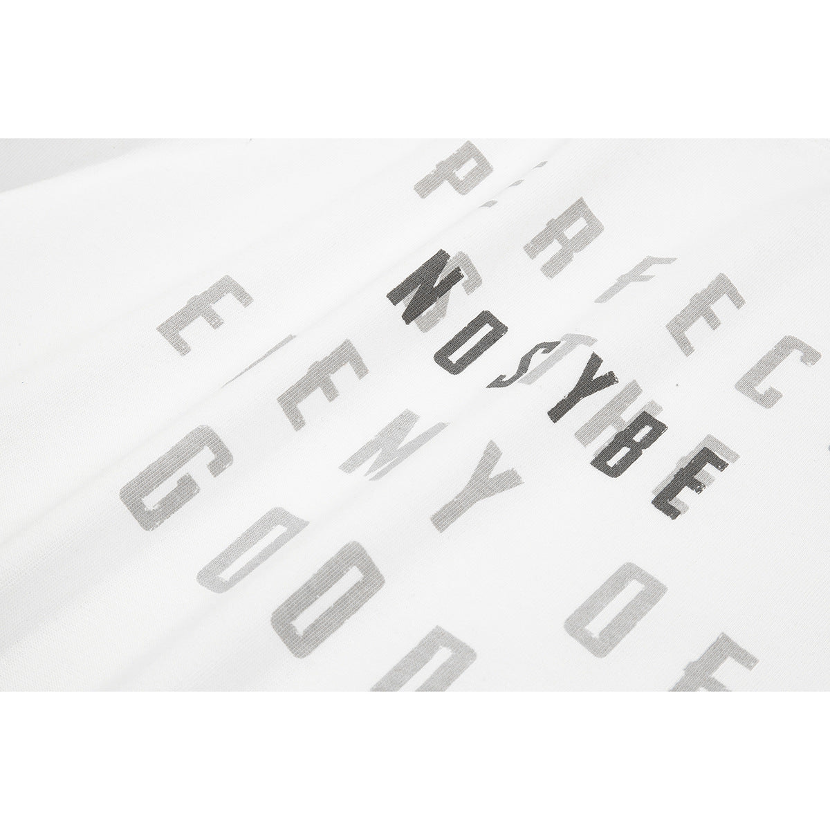 Close-up of angular gray and black lettering printed on white T-shirt fabric.