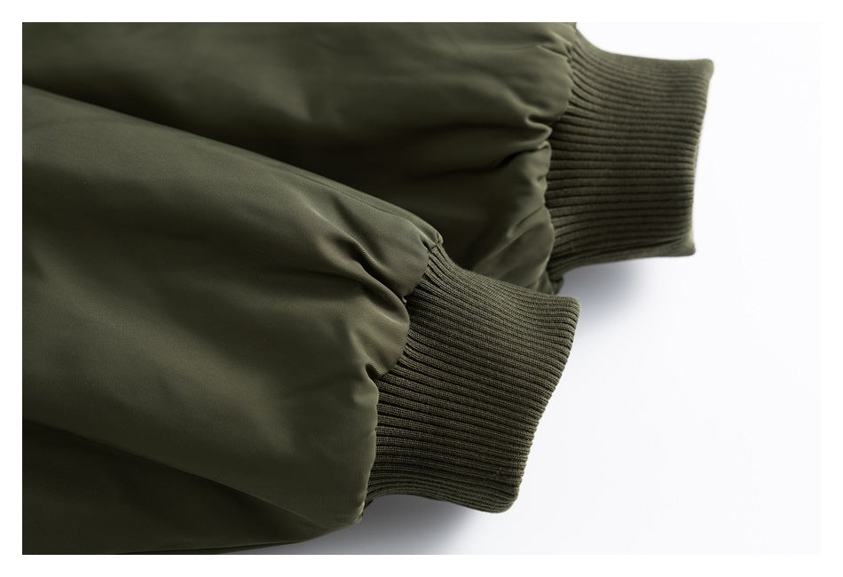Close-up of olive jacket sleeves with rib-knit cuffs.