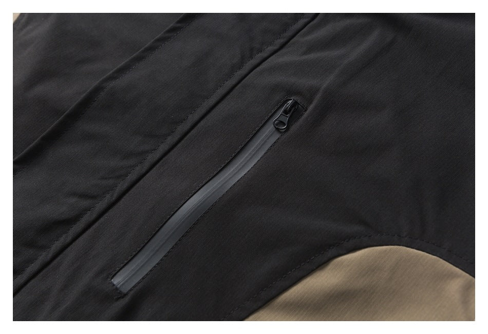Close-up of a black jacket with a vertical concealed zipper pocket.