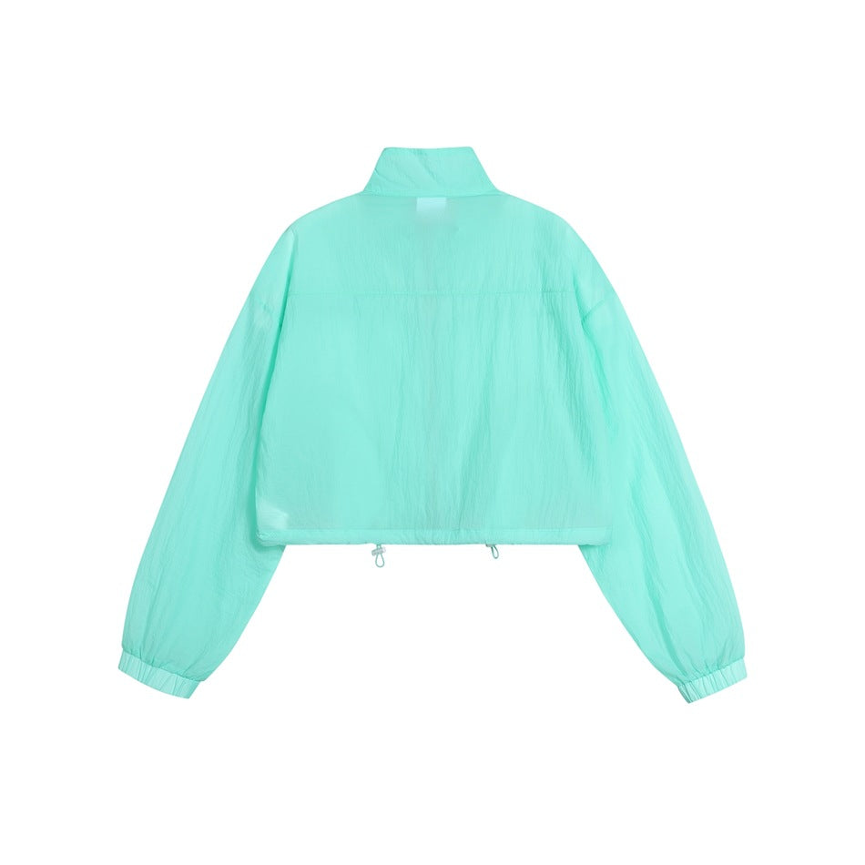 Back view of a mint-aqua cropped jacket with a high collar, loose long sleeves, elastic cuffs, and adjustable hem cords.