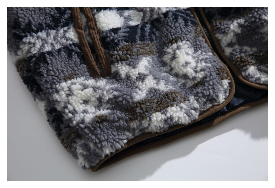 Close-up of gray, black, white, and brown patterned fleece with brown edging.