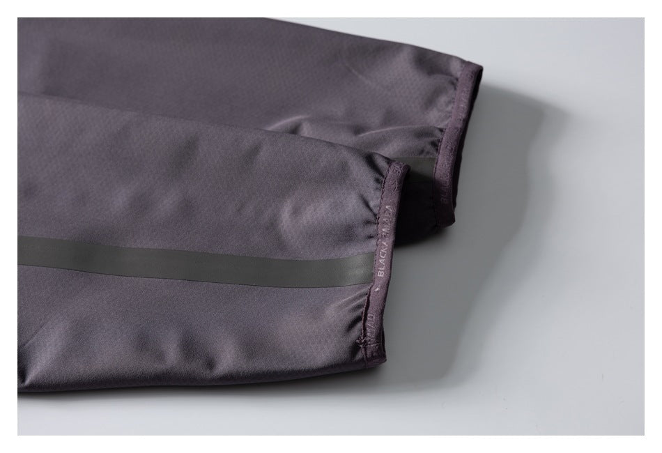 Close-up of a jacket sleeve cuff and dark seam-tape accent, with BLACKARMOR lettering on the edge.