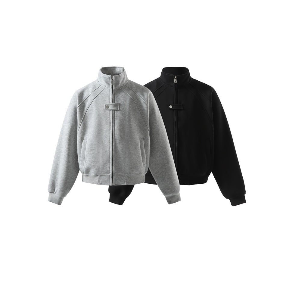 Two stand-collar zip jackets shown from the front: one heather gray and one black, both with snap tabs and ribbed hems.