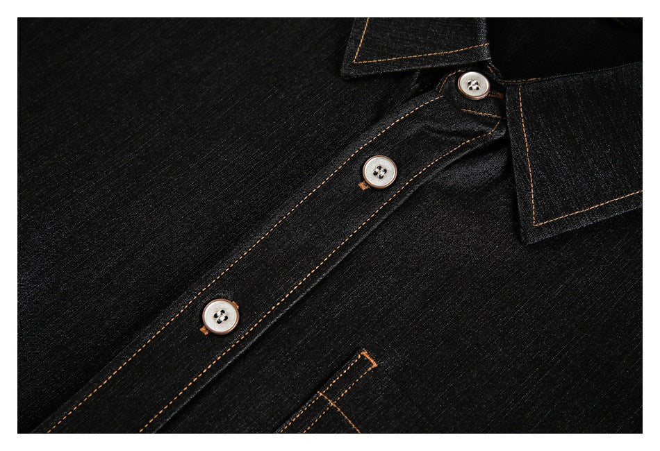 Close-up of the black denim shirt's button placket, silver buttons, collar edge, and tan stitching.