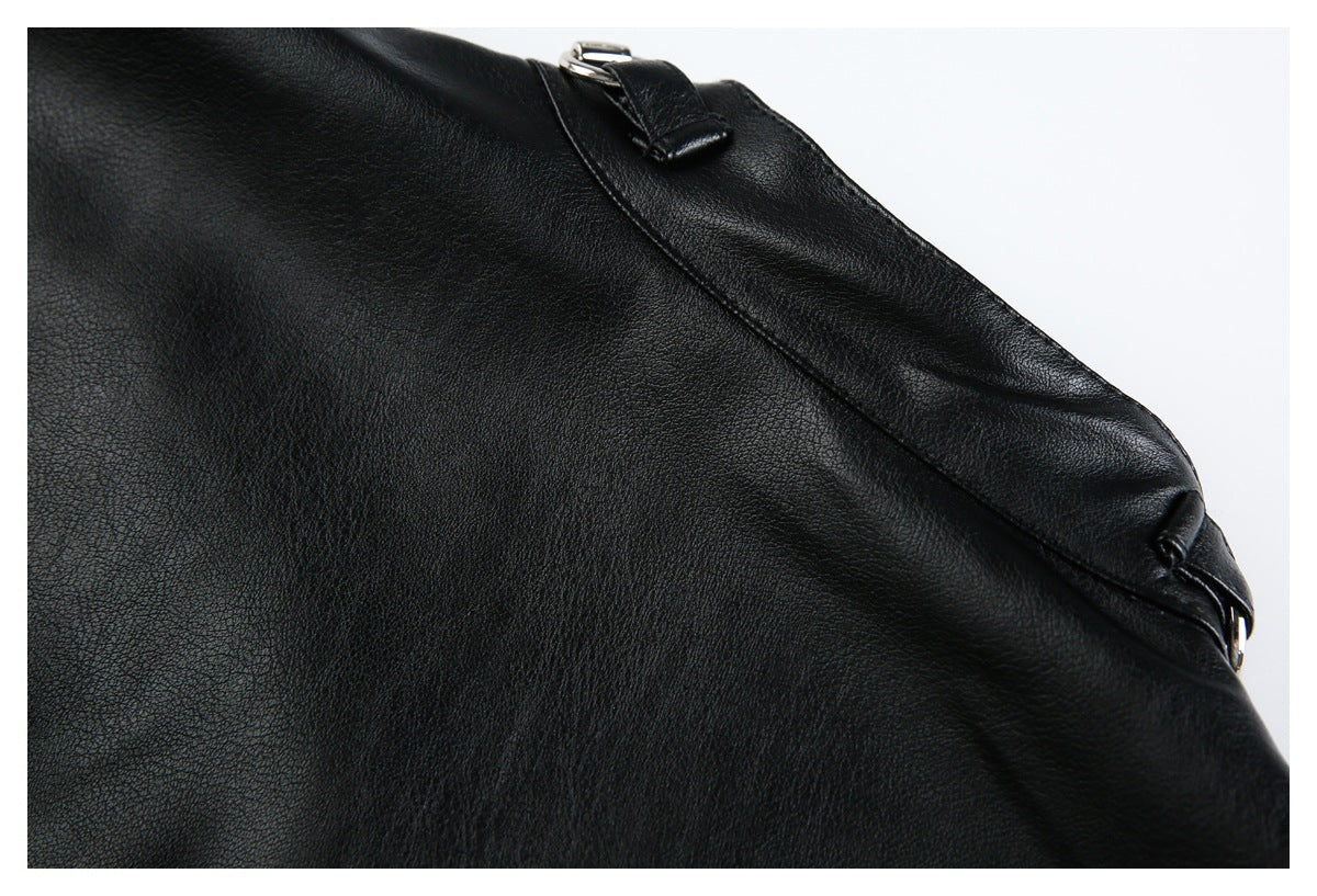 Close-up of a black jacket panel with a narrow strap and silver buckle hardware.