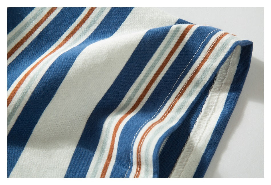 Close-up of a striped garment's folded edge with visible stitching and overlocked inside seam.